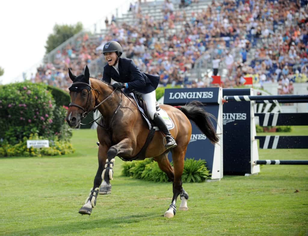 Karen Polle, riding With Wings, smiles after realizing she won the $250,000 Hampton Classic Grand Prix presented by Longines, Sunday, Aug. 30, 2015, in Bridgehampton, NY. (Photo by Diane Bondareff for Longines)