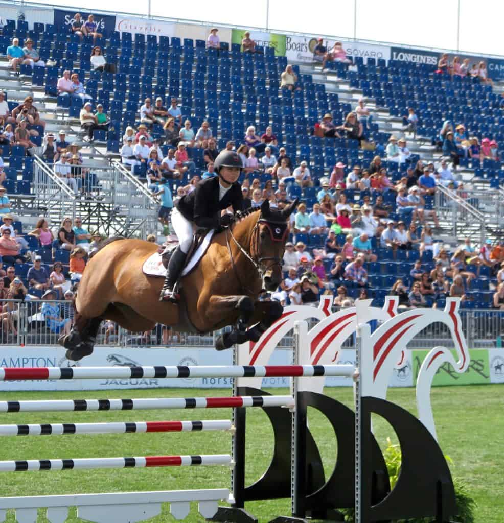 Georgina Bloomberg looking stylish in her Der Dau Red Sole Show Boots in the Grand Prix ring at Hampton Classic.